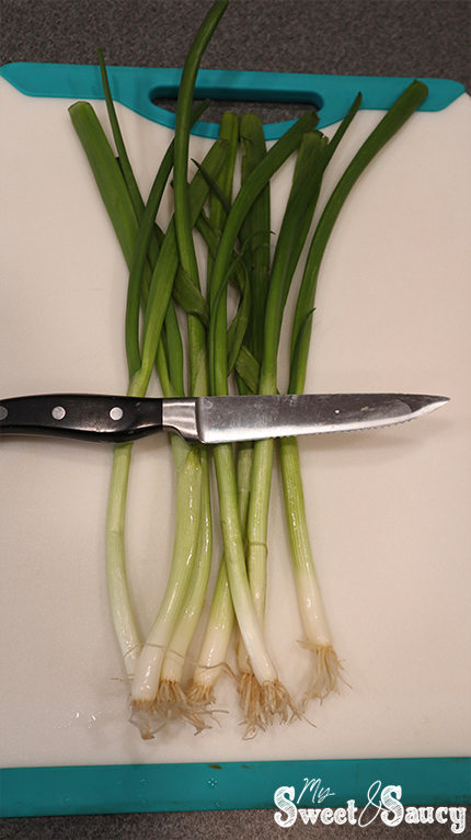 green onions with a knife