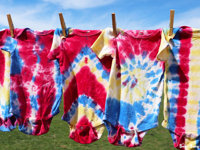 tie dye onesies on a cloths line