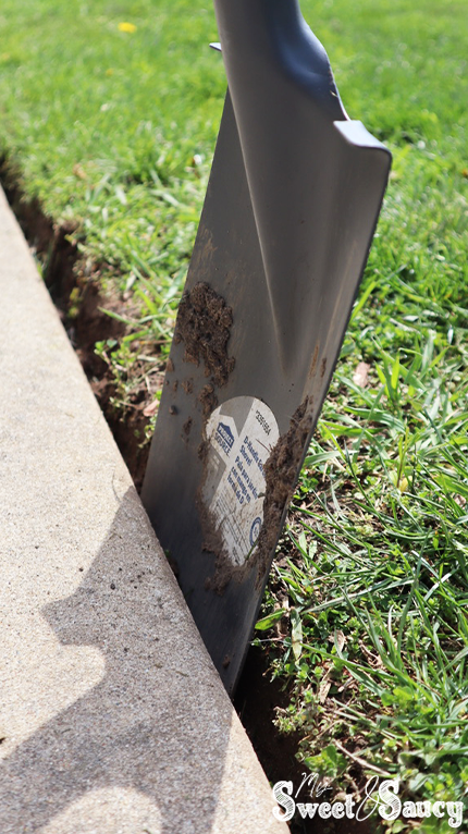 flat edge shovel by a sidewalk