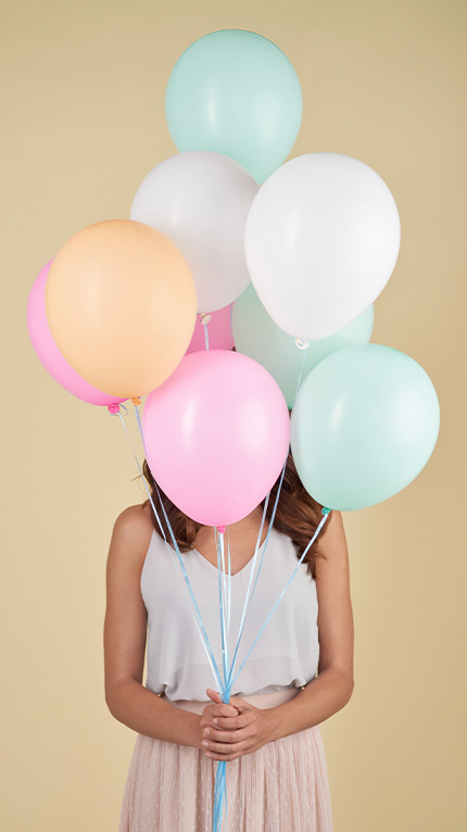 girl behind balloons