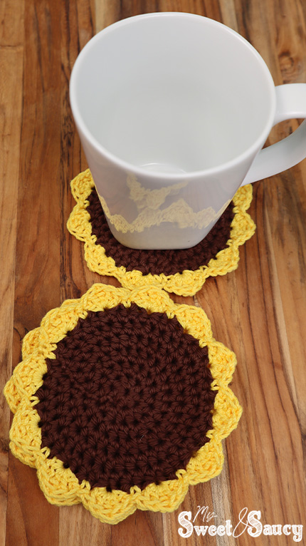 crochet sunflower coasters with a cup