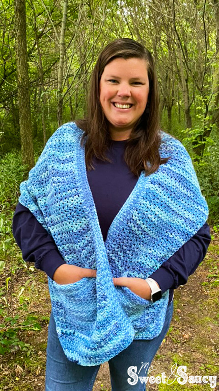 crochet pocket shawl with my hands in pockets